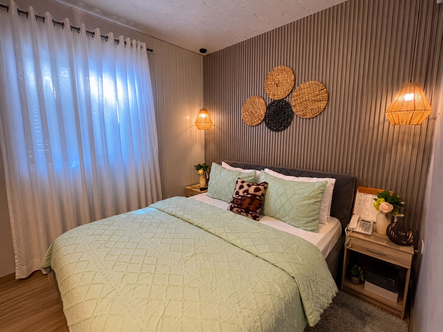 A quiet, minimally furnished room opening onto an ocean view.