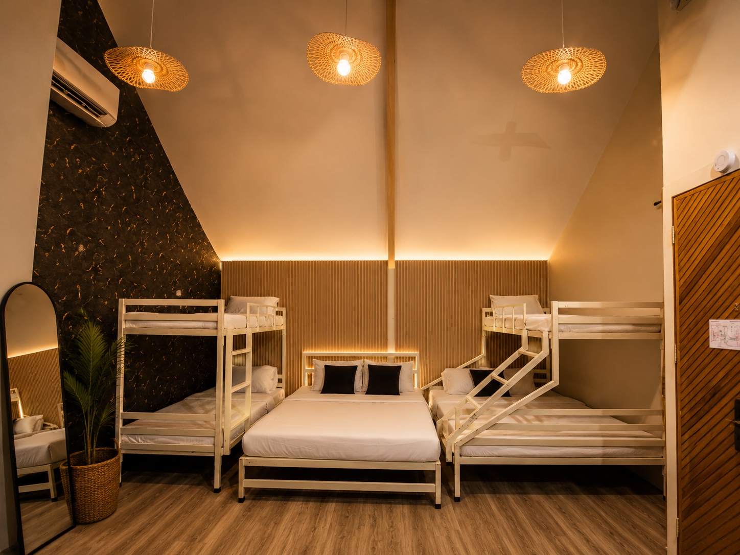 A quiet bedroom with natural textures and an ocean-facing deck.